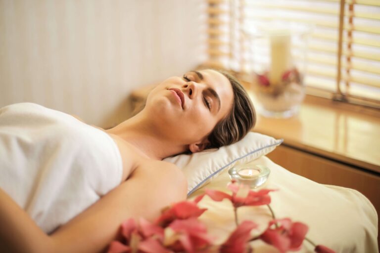 Woman in a state of relaxation surrounded with pink flowers
